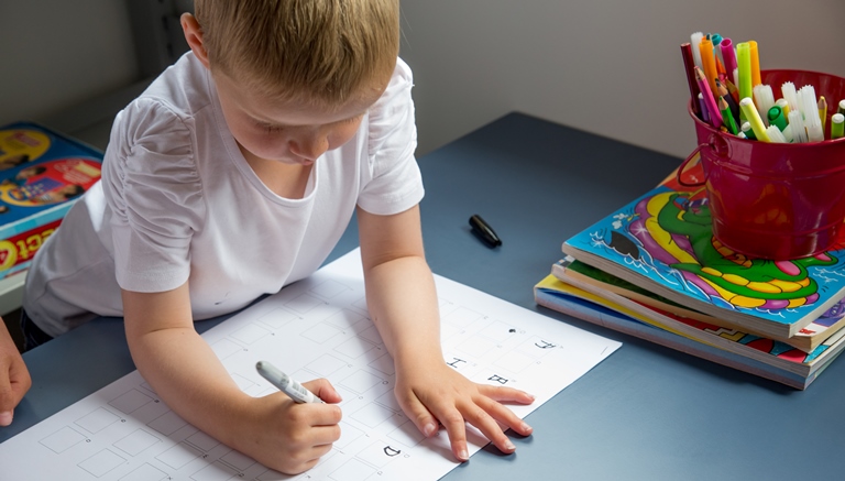 A preschooler writing