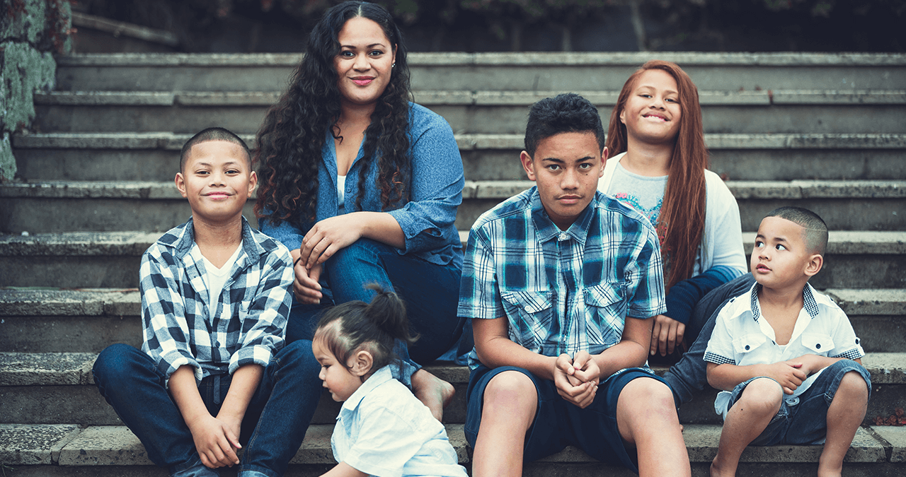 Family - mother and 5 children sitting on steps