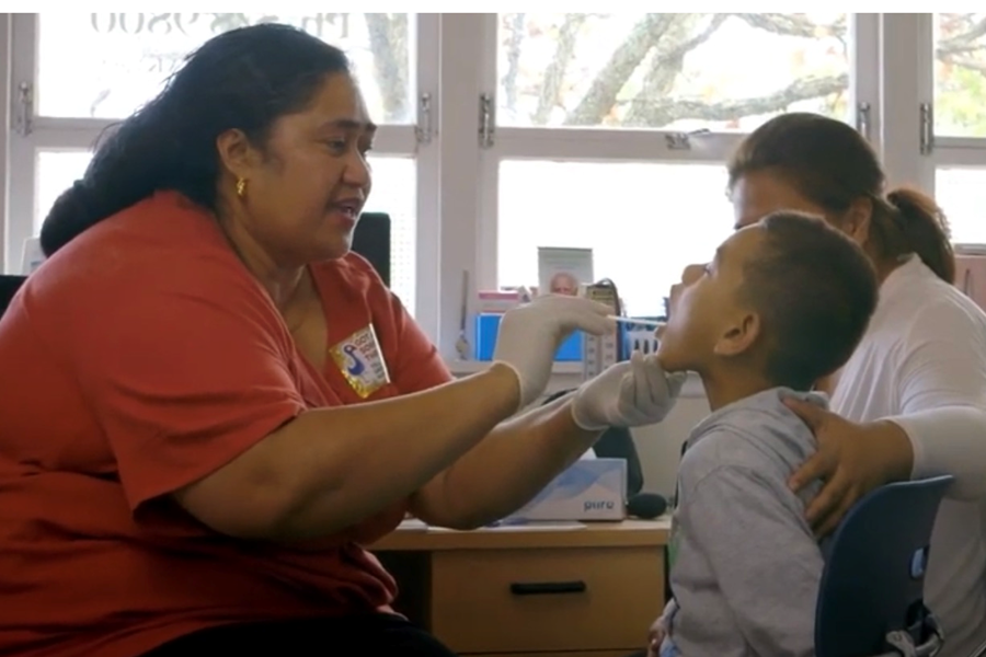 Boy having sore throat checked at a clinic