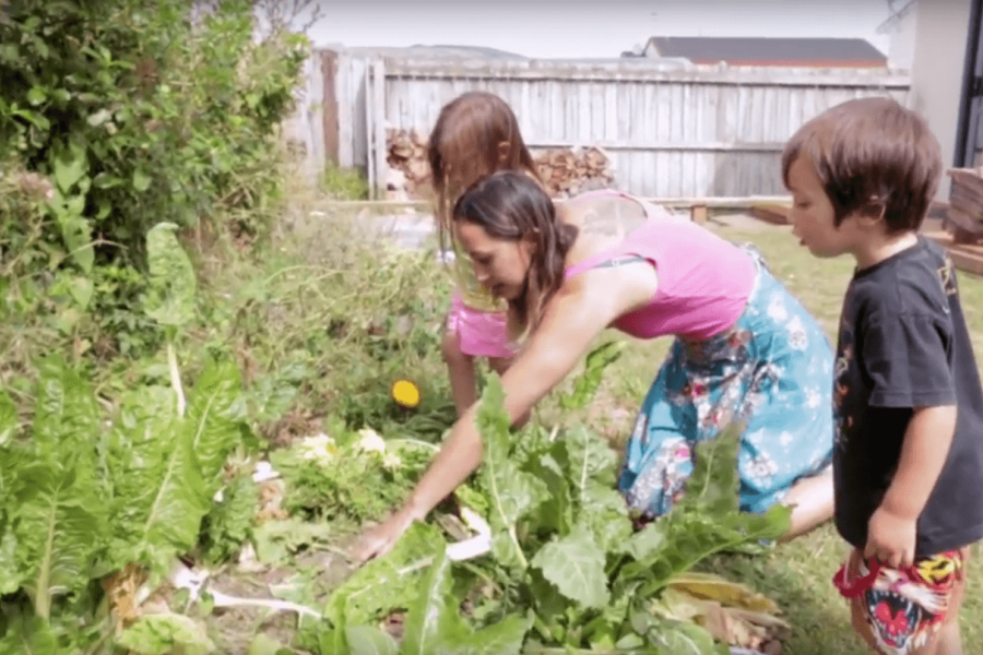 Mother with her 2 young children in the garden