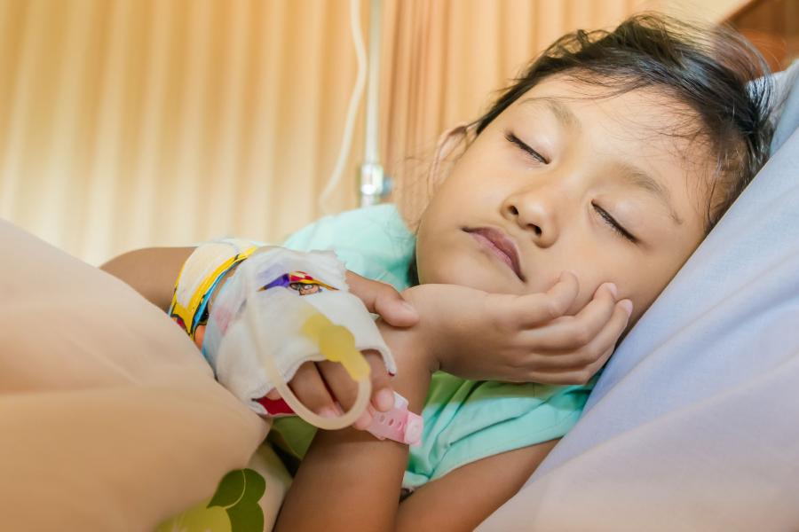 A young child in a hospital bed having treatment