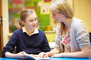 Photo of a student with their teacher 