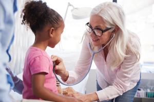 doctor examining child