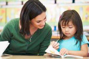 Child with teacher doing schoolwork