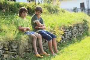 siblings sitting in the grass