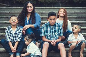 Family - mother and 5 children sitting on steps