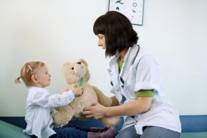 Doctor and child in doctor's consulting room