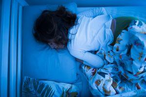 photo of a girl sleeping in her bed