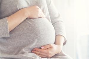 pregnant woman holding stomach 