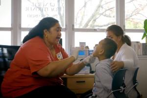 Child getting a throat swab by the nurse 